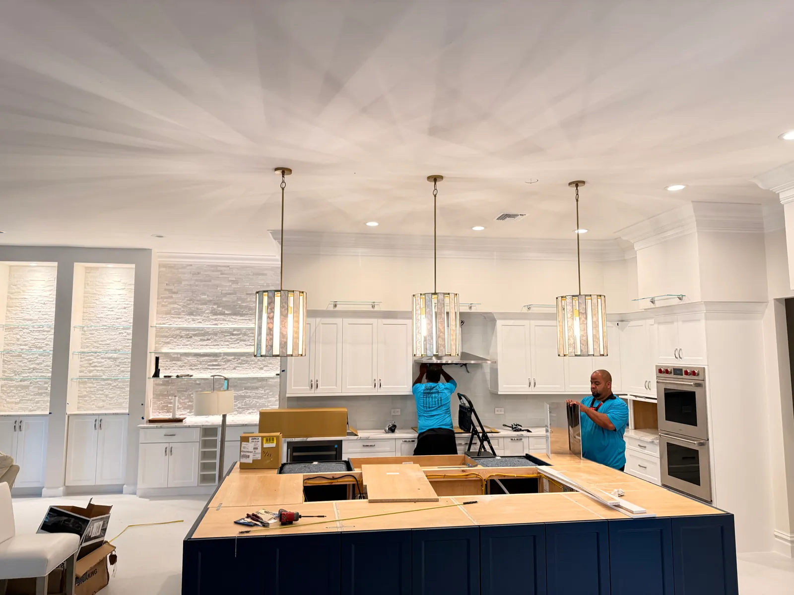 The A&V Power Pro team installing kitchen lighting on a completed job in Naples, FL